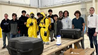 Program participants posing for a photo, some in protective gear